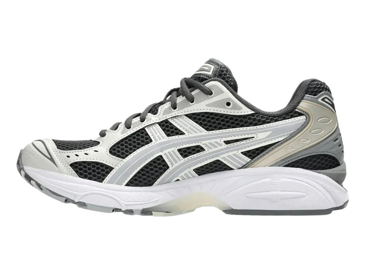 Tenis deportivos ASICS Gel-Kayano 14 en colores gris, blanco y negro con suela amortiguada.