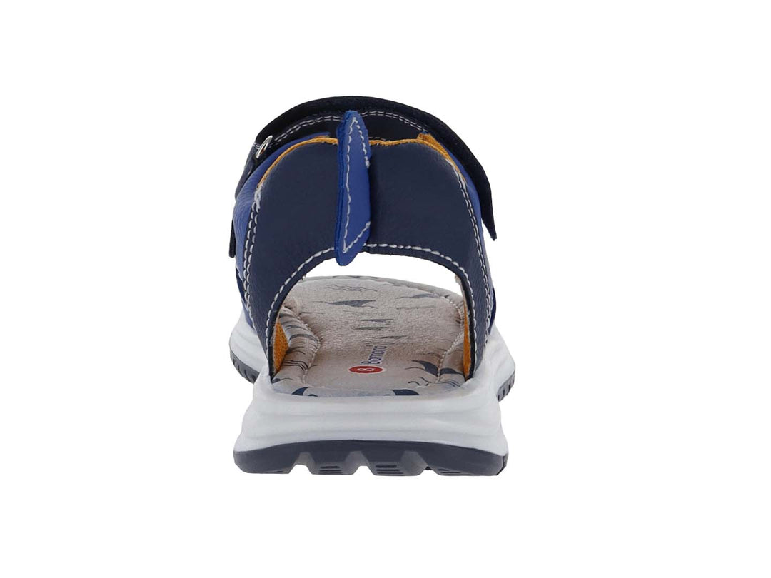 Sandalia infantil azul con diseño de tiburón, suela blanca y cierres de velcro.