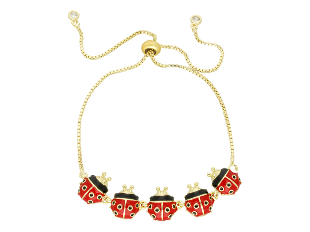 Pulsera dorada ajustable con cinco dijes de mariquitas en color rojo y negro.