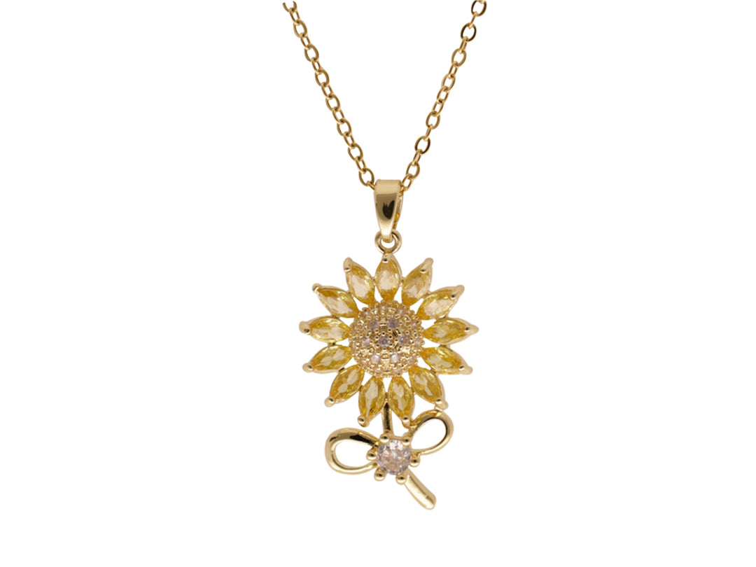 Collar dorado de la marca ROZE con un dije en forma de girasol adornado con cristales y un detalle de moño inferior.