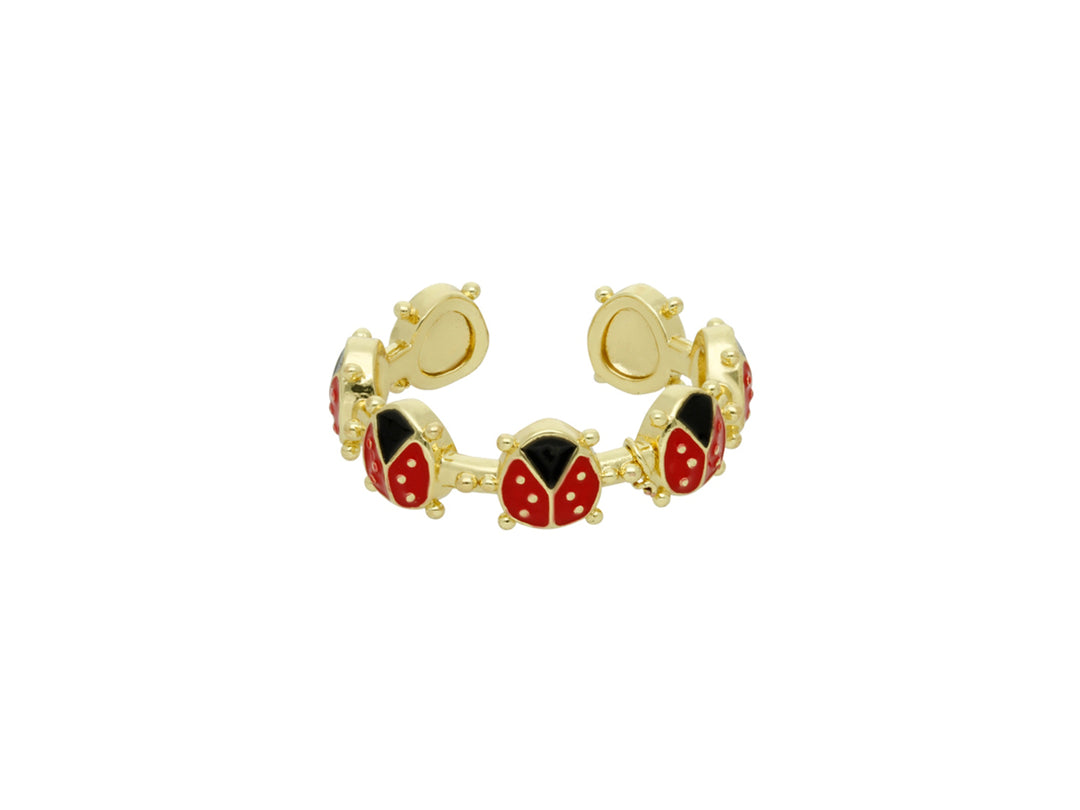 Pulsera dorada con figuras de mariquitas en color rojo y negro.