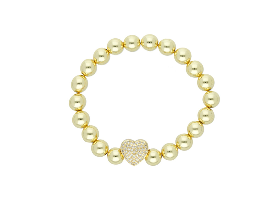 Pulsera dorada de cuentas esféricas con un dije central en forma de corazón brillante.