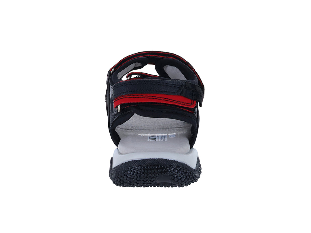Sandalia New Boys color negro con detalles en rojo y suela blanca.