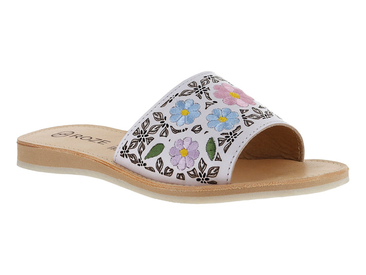 Sandalia blanca para niña con diseño de flores coloridas en la banda superior y suela beige.