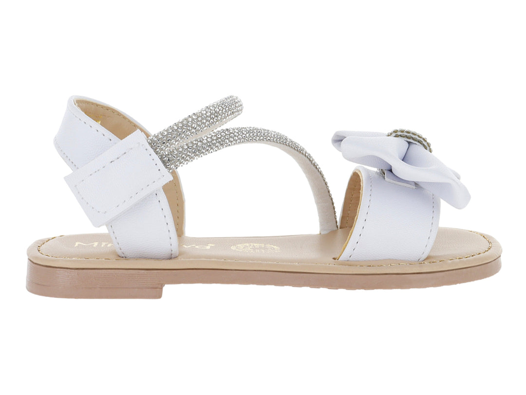Sandalias blancas para niña con detalle de moño y correa con glitter plateado.
