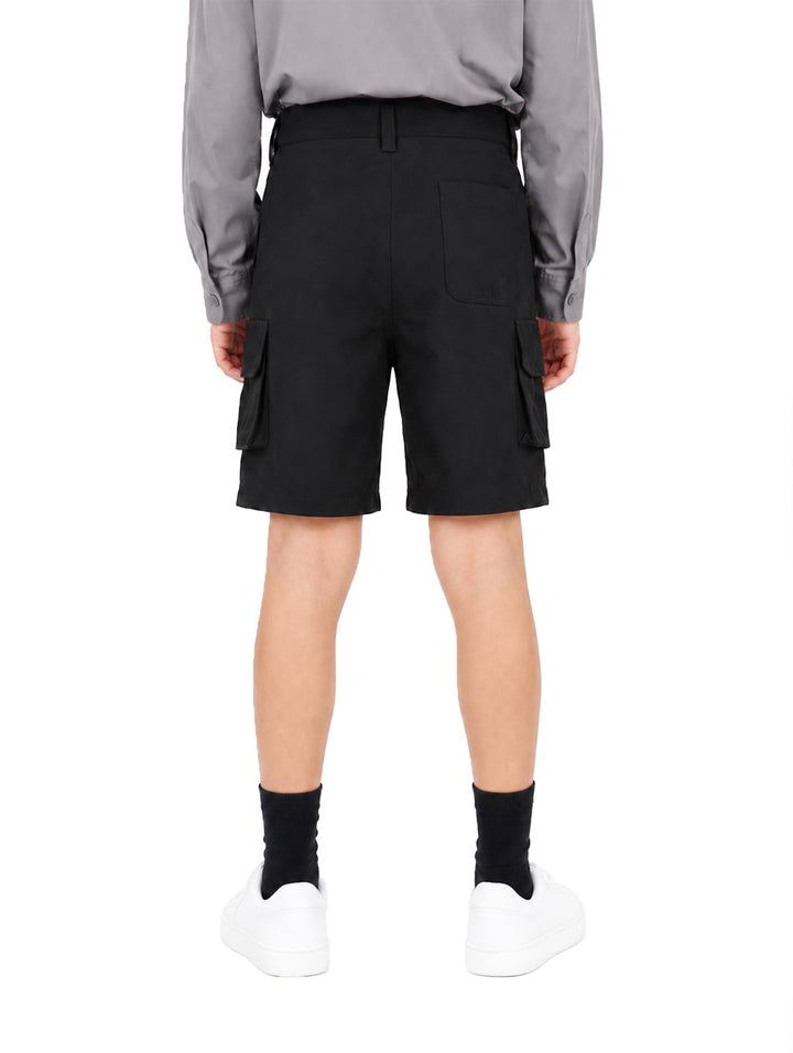 Bermuda color negro estilo cargo para niño, combinada con camisa gris y tenis blancos.