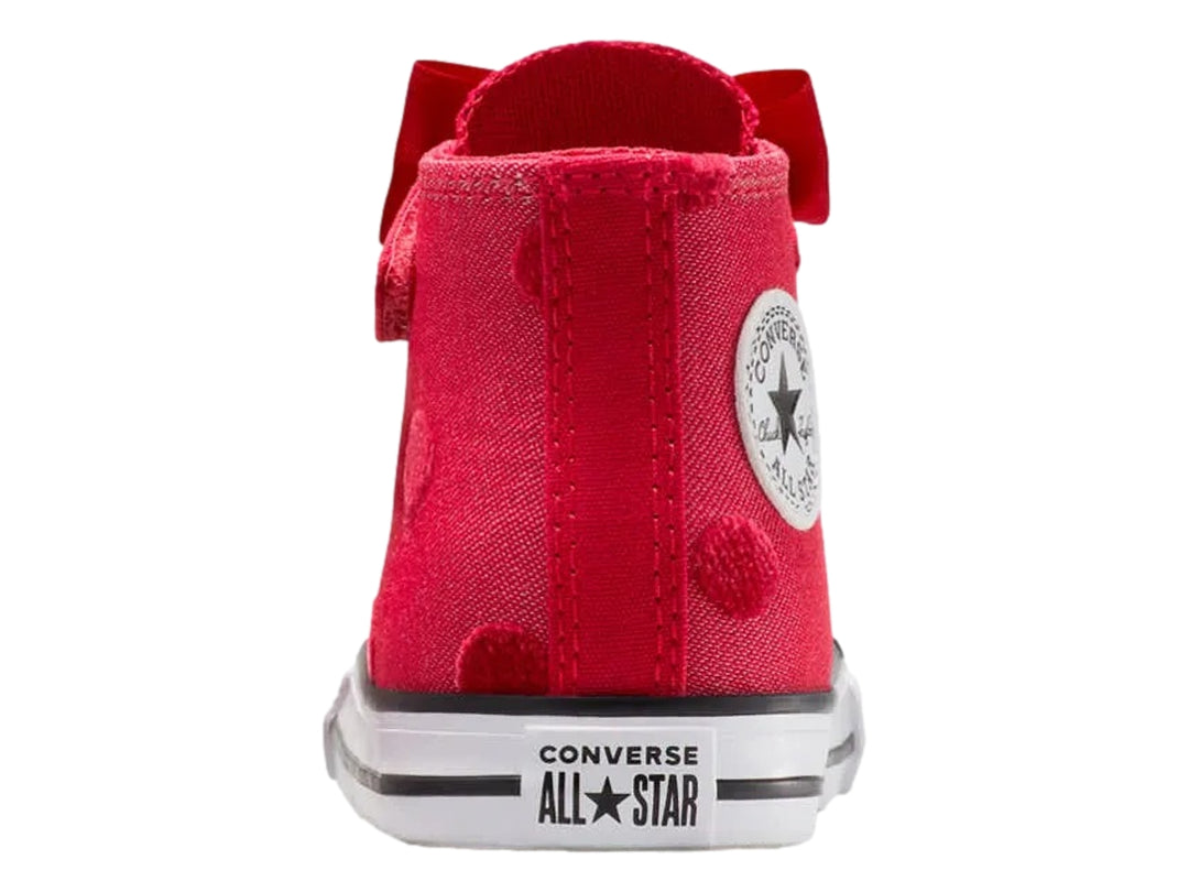 Tenis Converse rojos de bota con moño decorativo y suela blanca.