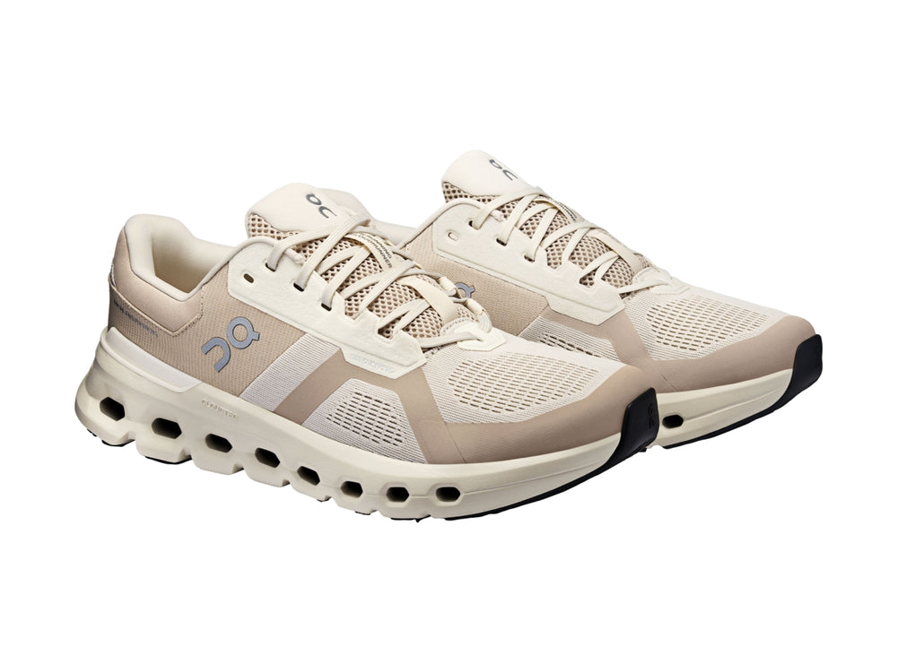 Tenis deportivos On Cloud en tonos beige y blanco con suela amortiguada característica.