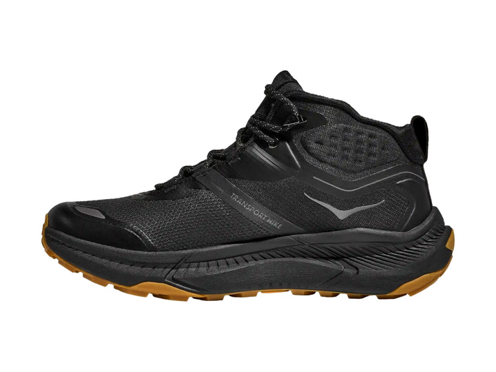 Bota de senderismo HOKA Transport Hike GTX en color negro con suela marrón y detalles técnicos.