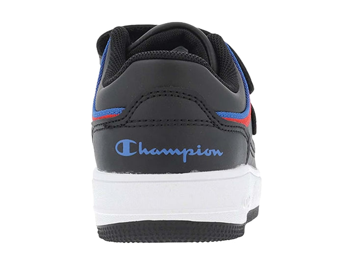 Tenis Champion negros con suela blanca, detalles en rojo y azul, y correa de ajuste.