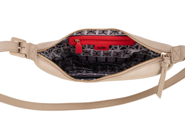 Bolso de hombro Cloe en color beige con diseño semicircular y correa larga sobre fondo blanco.
