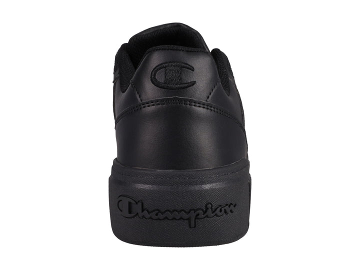 Tenis Champion color negro con suela gruesa y detalles perforados.