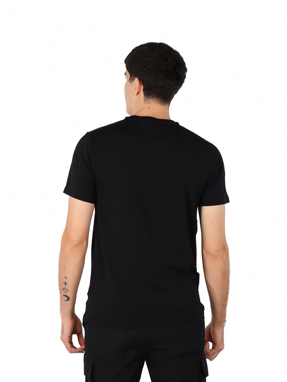 Hombre vistiendo una camiseta negra de manga corta con el logotipo de DKNY en el pecho.