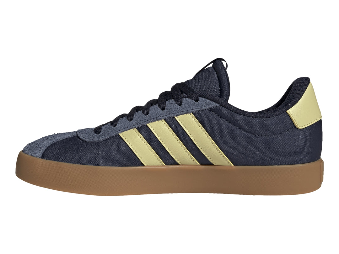 Tenis Adidas VL Court 3.0 color azul marino con franjas amarillas y suela de goma color café.