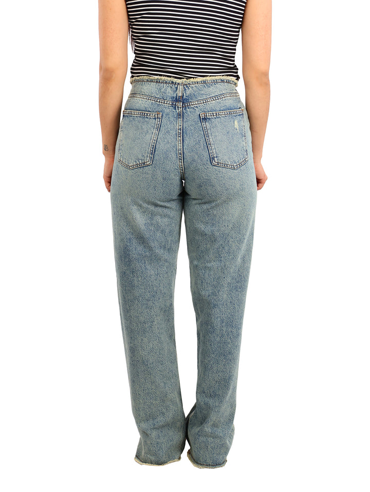 Pantalones de mezclilla azul claro de pierna ancha y cintura alta con detalles desgastados.