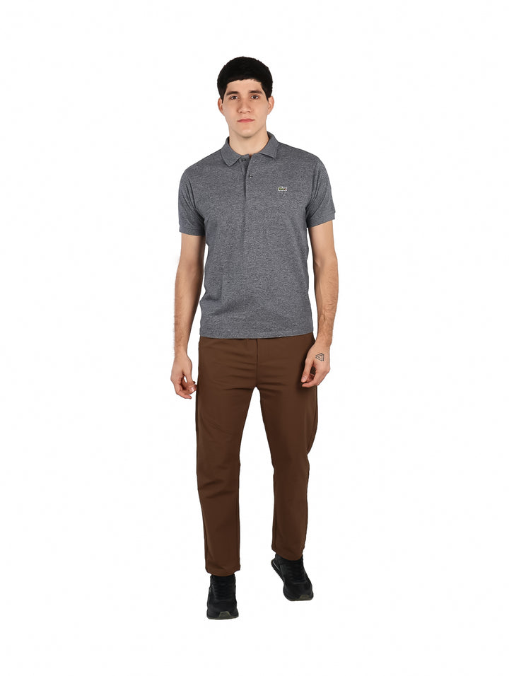 Hombre vistiendo una playera polo de color gris jaspeado con cuello y botones.
