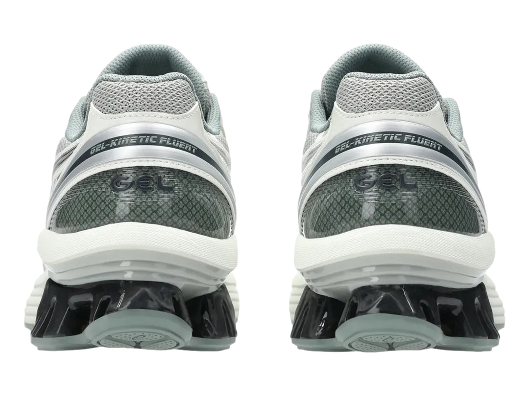 Tenis deportivos ASICS color gris y plata con suela blanca y detalle negro brillante en el talón.