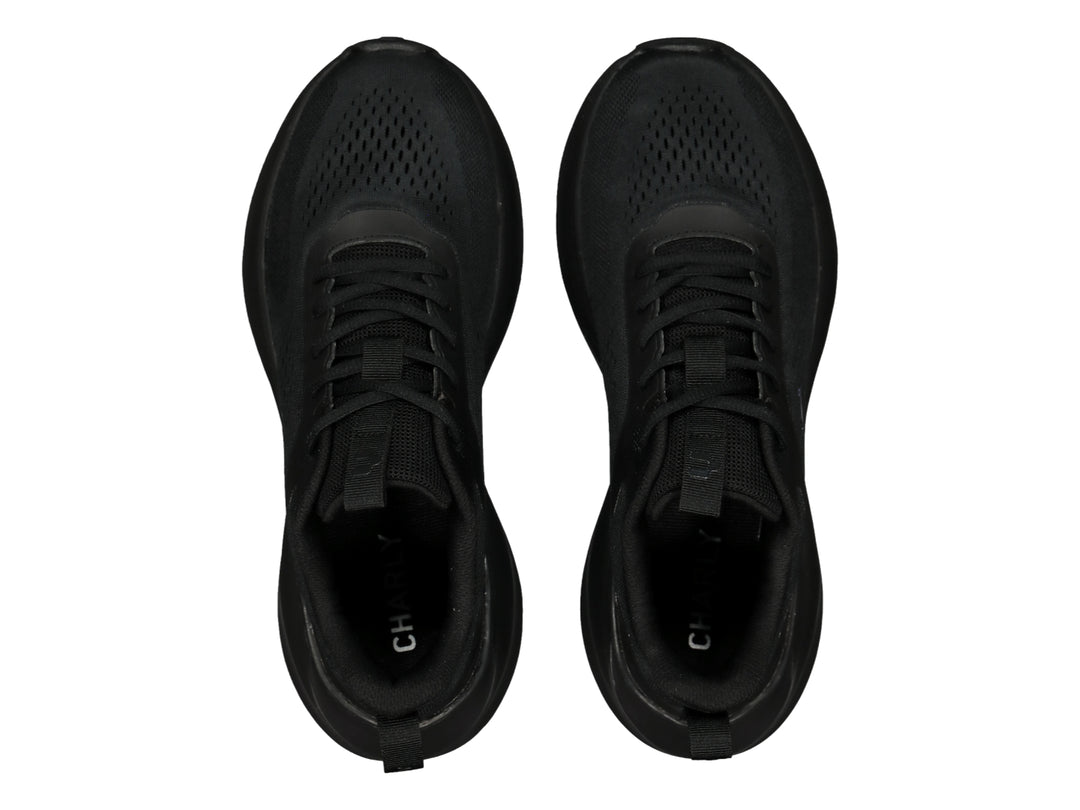 Tenis deportivos Charly color negro con tejido de malla y suela gruesa.