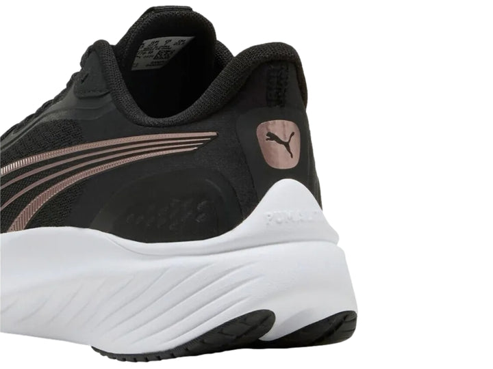 Tenis PUMA Pounce Lite en color negro con suela blanca y detalles decorativos en oro rosa.