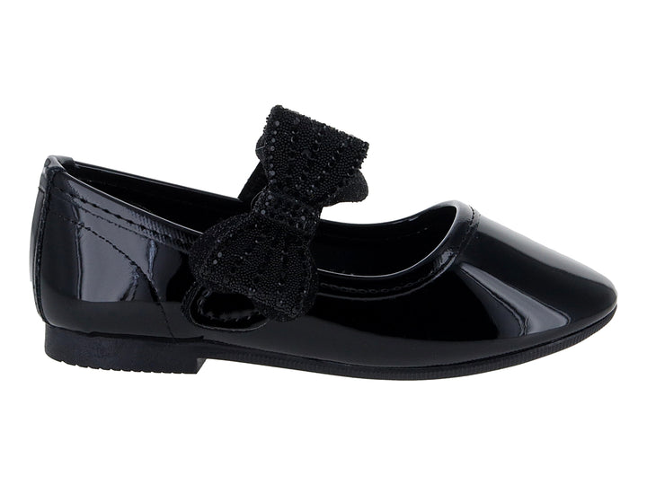 Zapato plano de charol negro para niña con un moño decorativo brillante en la parte superior.