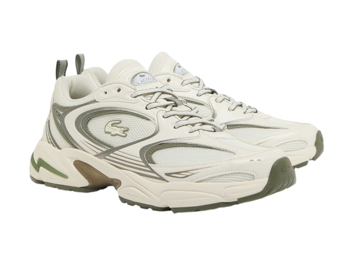 Tenis deportivos Lacoste en color blanco roto y caqui con suela gruesa y diseño chunky.