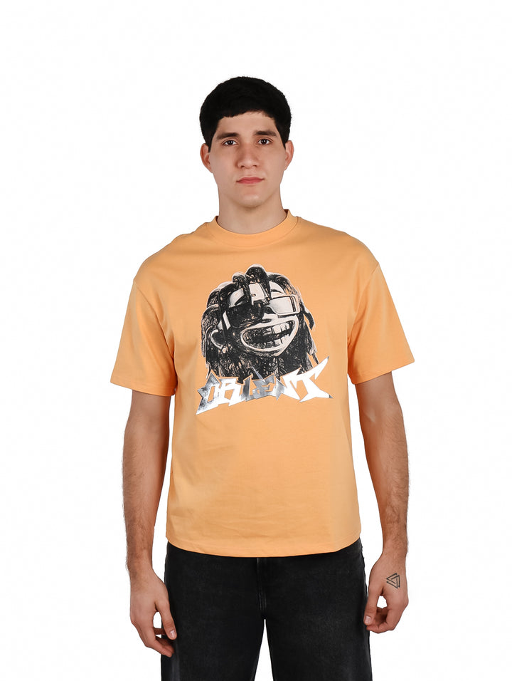 Hombre vistiendo playera oversize color anaranjado con estampado gráfico en el pecho.