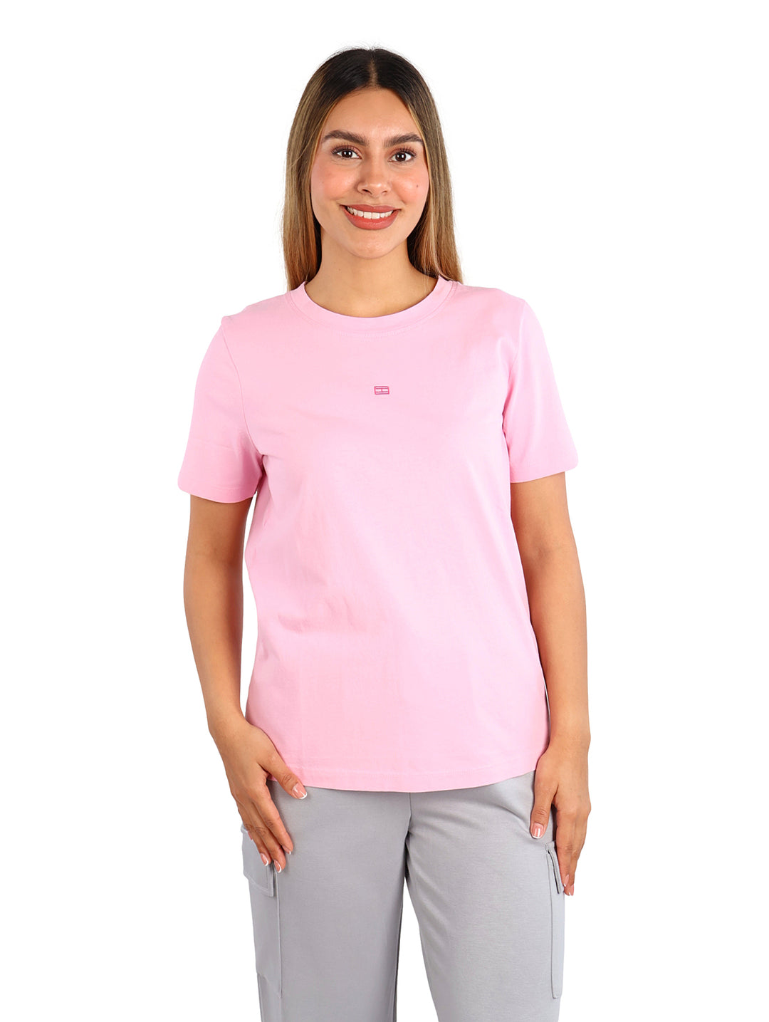 Mujer vistiendo una playera rosa de manga corta y cuello redondo.