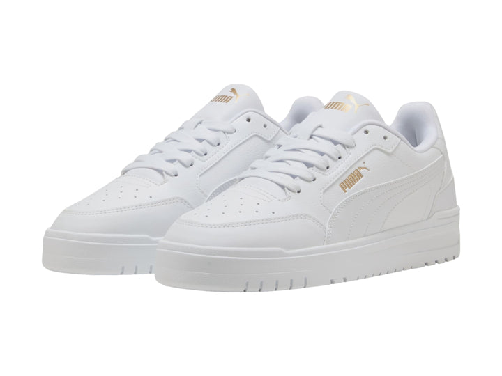 Tenis PUMA Shuffle Downtown color blanco con detalles dorados, vista lateral.