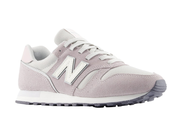 Tenis New Balance color gris claro con detalles en blanco y suela blanca.