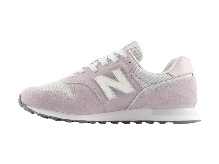 Tenis New Balance color gris claro con detalles en blanco y suela blanca.