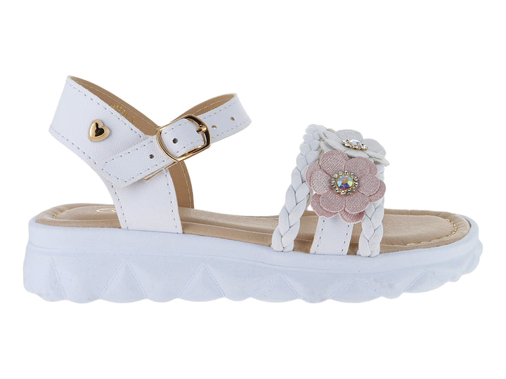 Sandalia blanca de plataforma para niña con detalle de flor rosa y correa ajustable con hebilla dorada.