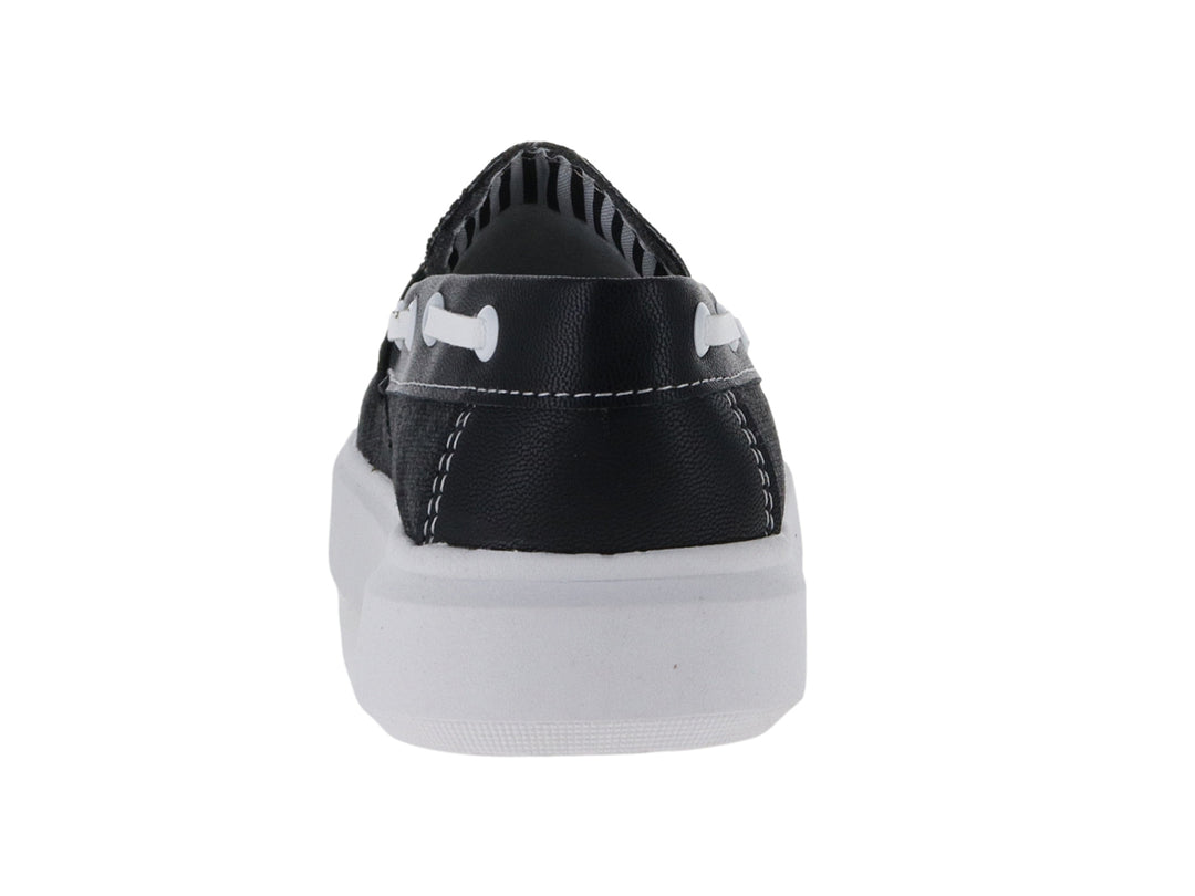 Zapato tipo mocasín de lona color negro con suela blanca para niño.