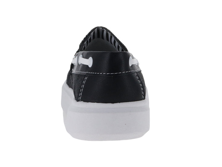 Zapato tipo mocasín de lona color negro con suela blanca para niño.