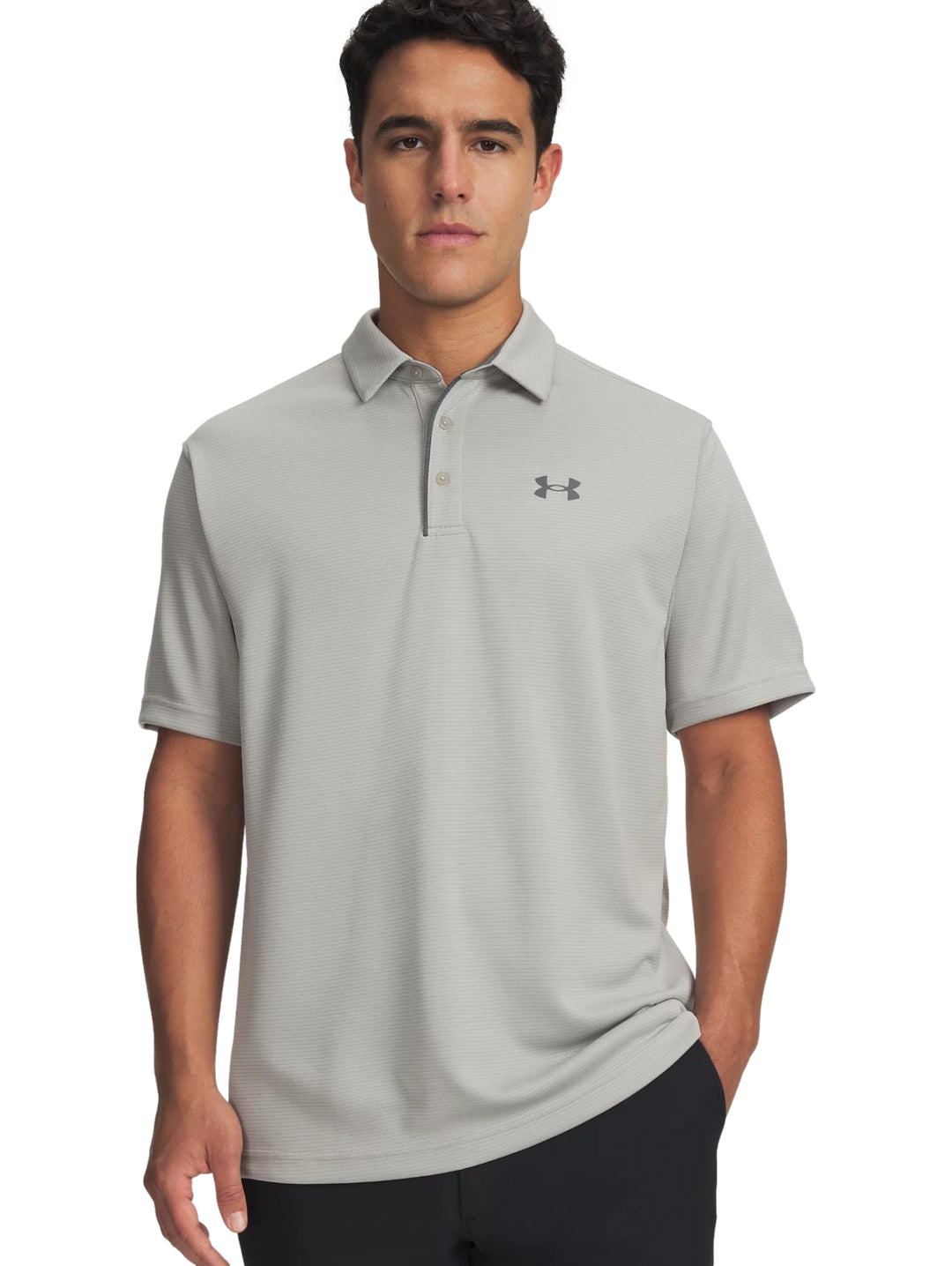 Hombre vistiendo una playera polo Under Armour de color gris con cuello y manga corta.