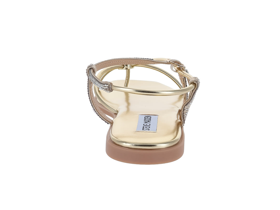 Sandalias planas doradas con tiras decoradas con brillantes y suela beige de Steve Madden.