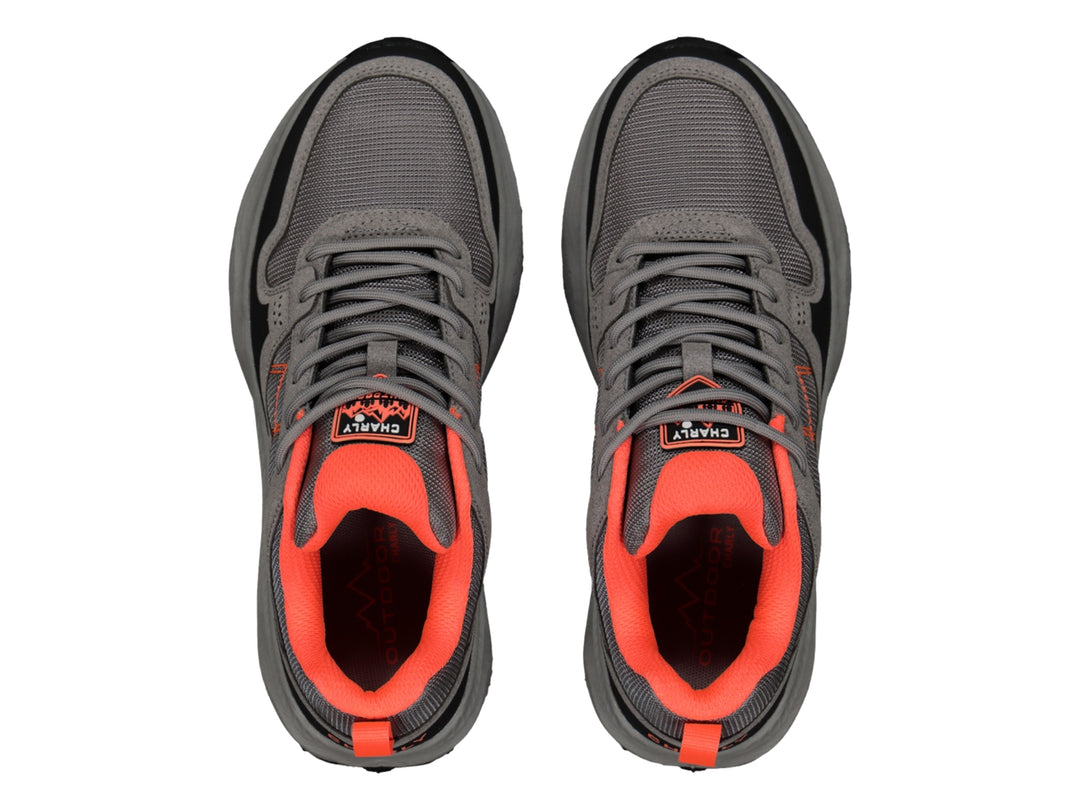 Tenis deportivos Charly color gris con detalles en naranja y negro, vista lateral.