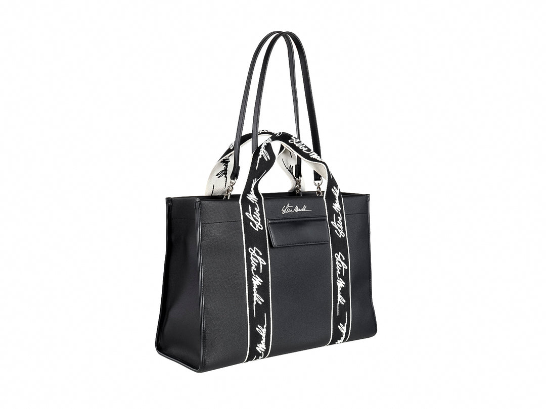 Bolso tote negro Steve Madden con bandas verticales blancas y asas largas coordinadas.
