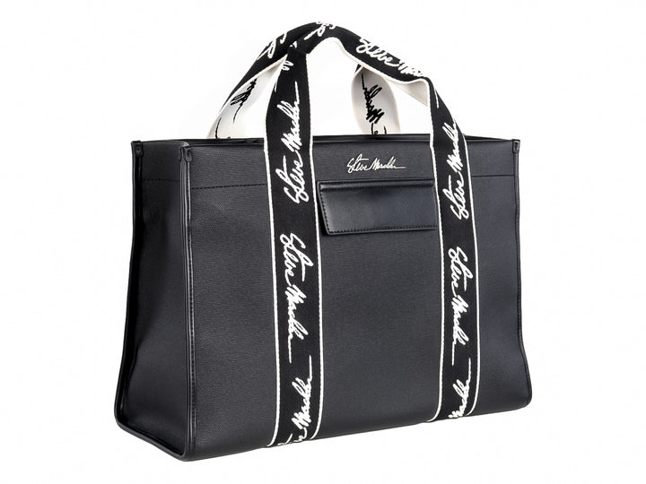 Bolso tote negro Steve Madden con bandas verticales blancas y asas largas coordinadas.