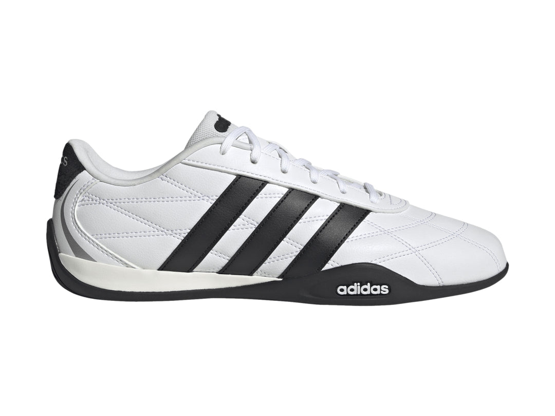 Tenis Adidas Adipista color blanco con tres franjas negras laterales y suela negra.