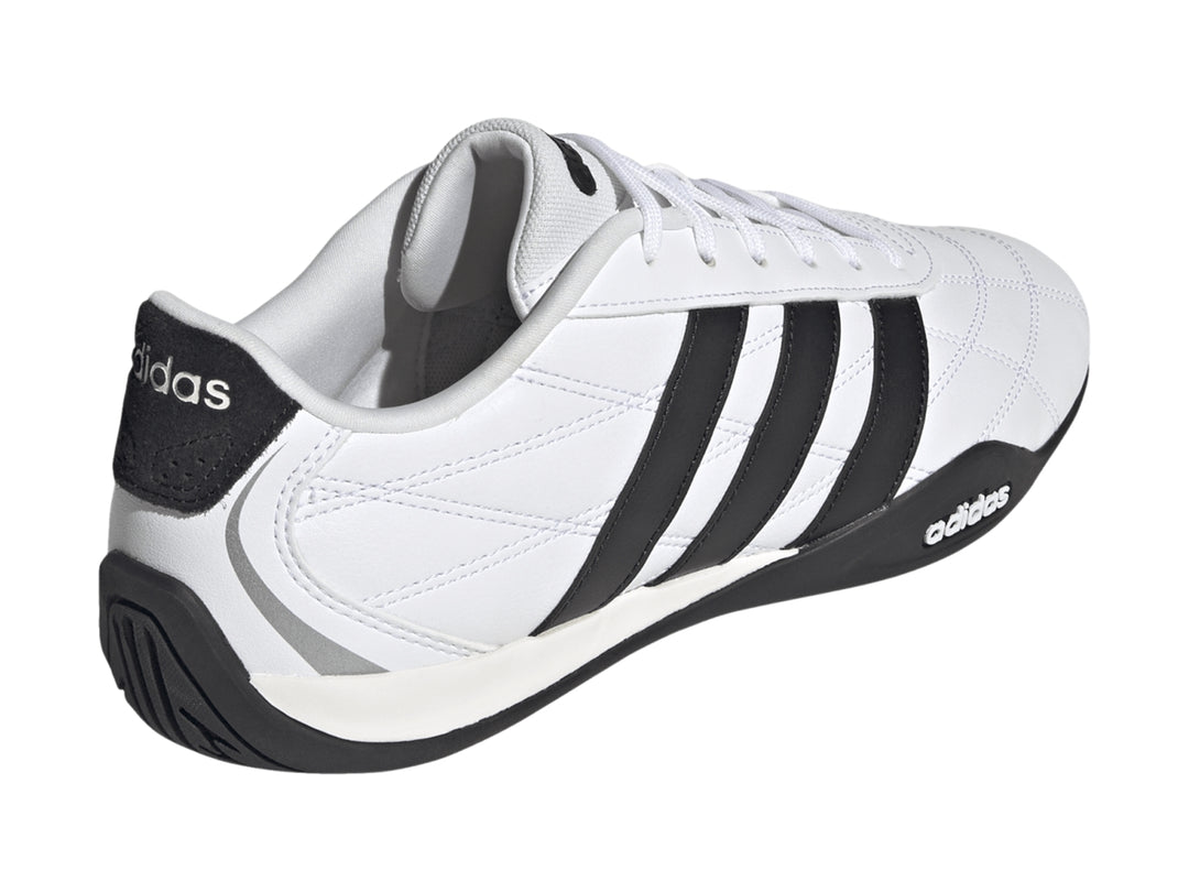 Tenis Adidas Adipista color blanco con tres franjas negras laterales y suela negra.