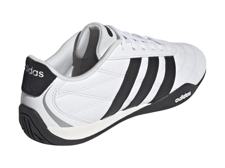 Tenis Adidas Adipista color blanco con tres franjas negras laterales y suela negra.