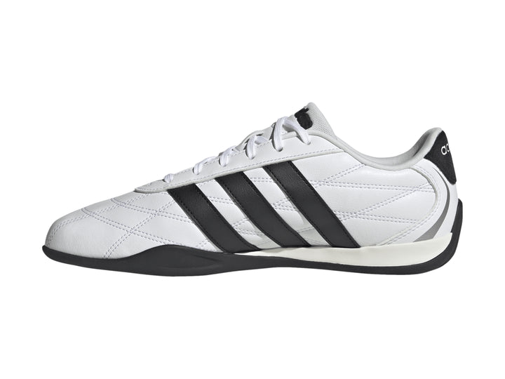 Tenis Adidas Adipista color blanco con tres franjas negras laterales y suela negra.