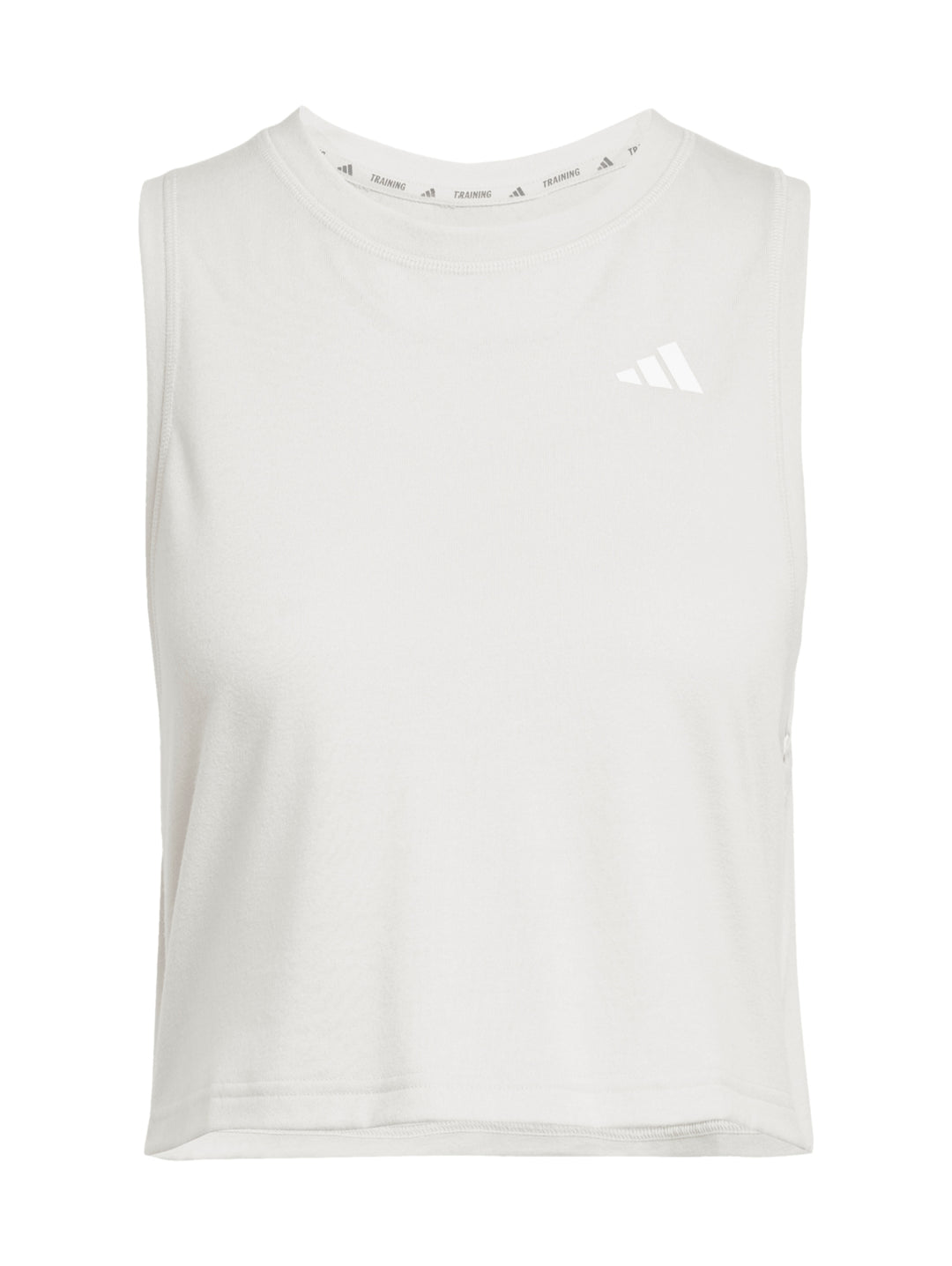 Mujer vistiendo una camiseta deportiva sin mangas de color crema marca Adidas con corte boxy.