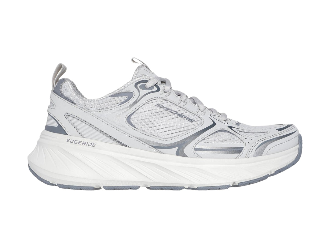 Tenis deportivos Skechers para mujer en color gris y blanco con suela blanca gruesa.