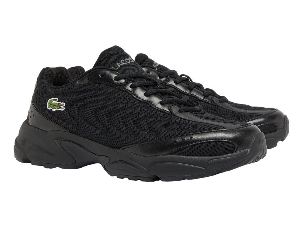 Tenis deportivos Lacoste en color negro con suela gruesa y detalles en malla.