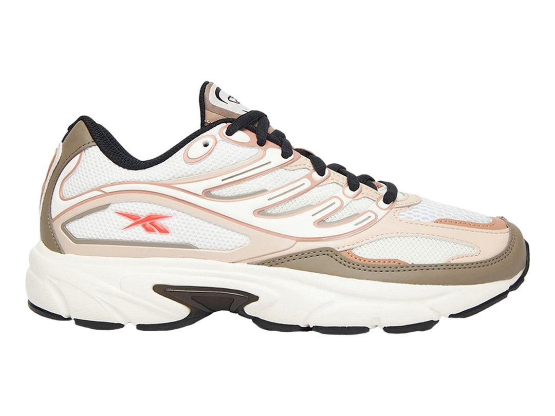 Tenis Reebok Premier Road Control en colores gris, beige y rosa con suela blanca y detalles en negro.