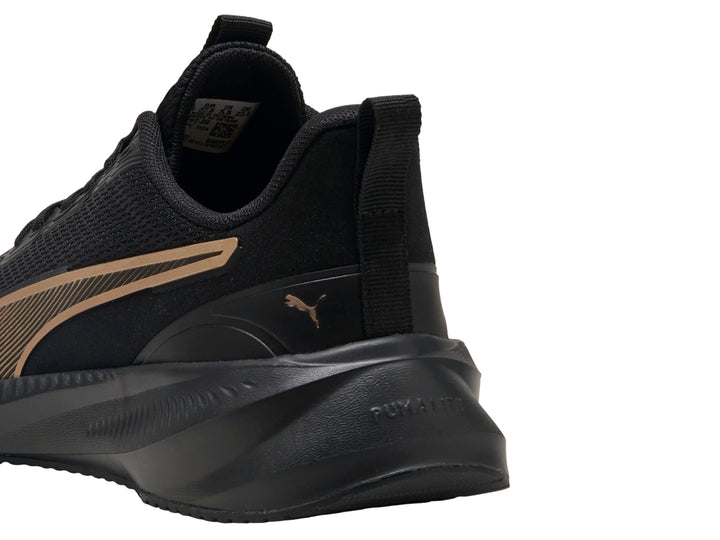Tenis deportivos PUMA color negro con franja lateral en dorado y suela negra.