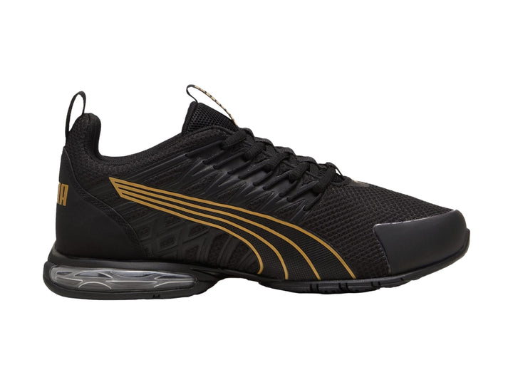Tenis deportivos PUMA color negro con rayas en oro rosa y cámara de aire en el talón.