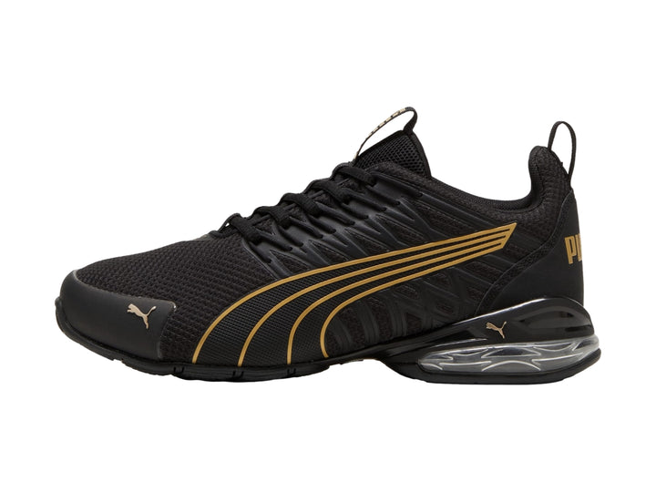 Tenis deportivos PUMA color negro con rayas en oro rosa y cámara de aire en el talón.