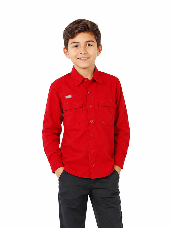 Niño vistiendo una camisa de manga larga color rojo intenso con bolsillos frontales y cuello.